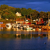 Sunsetting Bay: This view lasted all but a few brief moments.  I caught this image at dusk just as a light rain storm was finished passing through in the background, a laser beam of sunlight burst through the clouds from the west and focus illuminated on this tiny fishing village in Prince Edward Island, Canada.